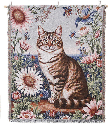 Woven blanket with a cat and floral design, featuring brand logos on a white background.