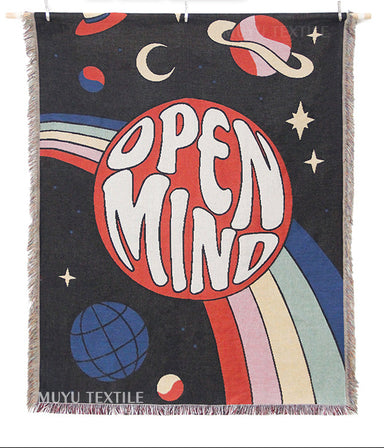 Woven blanket with 'Open Mind' design and branding elements.